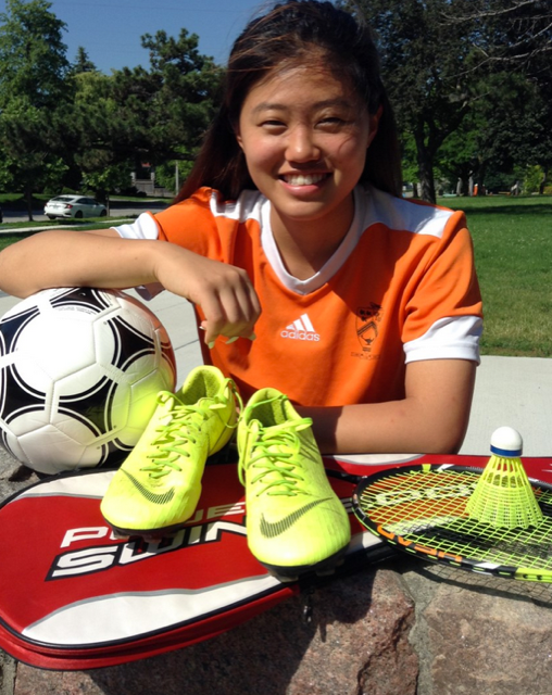 Athlete of the year Ju Eun Lee from Martingrove CI smiling with equipment from the many sports she played.